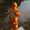 Stüssy x Denim Tears Fall Winter 2026 Collection Orange Hooded Jacket
